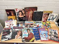 Photo showing a variety of magazines including Life, Time, Screen Annual, TV Show, Keyboard, Holmes & Co., and others arranged facing forward showing covers.