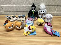 Full lot of plush toys arranged on wooden surface
