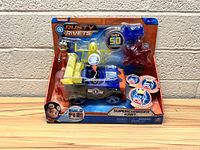Front view of Rusty Rivets Supercharged Kart toy in original packaging, showing the kart, character figure, and various components.