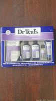 Front view of Dr Teal's gift set in original packaging showing the contents including Epsom salts and bottles of body wash, foaming bath, body oil and lotion.