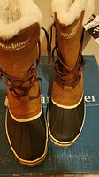 Front view of both boots placed on the original WindRiver box