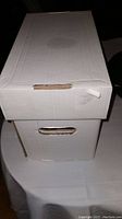 White cardboard long box closed