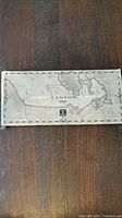 Closed beige box with a map of Canada and text 'CANADA 1999' showing outer packaging of coin set.
