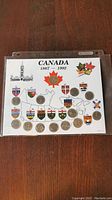 Canadian coin set displayed on a card with Canadian emblems and shields from 1867 to 1992