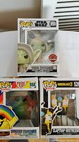 Photo showing all three Funko Pop! figures boxed: Star Wars Yoda (Hooded), SpongeBob SquarePants PRIDE, and Borderlands 3 Claptrap (Distressed).
