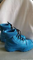 Side view of one bright baby blue Converse All Star boot showing design and lacing.