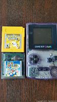 Overhead view of Game Boy Color console alongside two cartridges (Pokémon Yellow and Super Mario Bros.)