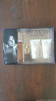 Front view of Elizabeth Taylor White Diamonds gift set with perfume bottle, two tubes and box featuring Elizabeth Taylor portrait and branding.