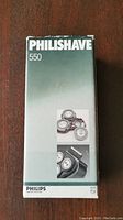 Photo of the front face of the Philips Philishave 550 shaver box showing the model and brand name with an image of replacement shaving heads and a photo of the shaver itself.