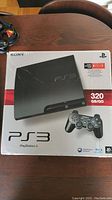 Front view of PlayStation 3 box showing console and controller images, 320GB capacity, and Netflix compatibility.