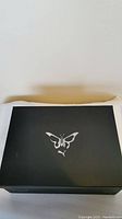 Black Puma shoe box with butterfly logo on the lid.