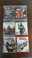 Front cover of 6 PlayStation 3 game cases showing titles and cover art.