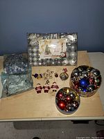 Wide view showing all Christmas ornament items together on table.