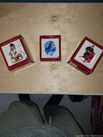 Three boxed Elvis Presley Christmas ornaments on table