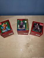Three boxed Elvis Presley Christmas ornaments with various themes visible on the boxes.