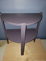 Front view of the purple half moon table showing both shelves and legs.