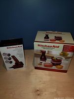 Photo of KitchenAid Food Chopper and Bowl Set box showing several bowls with lids in burgundy and white colors.