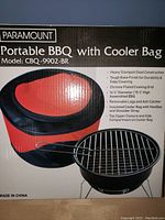 Box front of Paramount Portable BBQ with Cooler Bag showing model CBQ-9902-BR, product features, and images of BBQ and cooler bag.