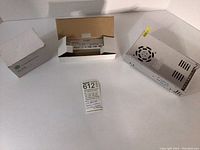 All three items in the lot shown together on a white surface: metal power supply, boxed LED driver, and boxed volume control unit.