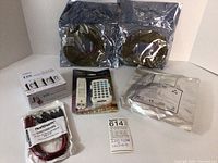 Photo showing all lot contents including two unopened LED light strip reels, LTECH Mini LED Remote Controller package, Northern Video 12VDC bare lead adapters in sealed bag, and the LTECH DX Series Touch Panel controller box.