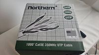 Closed box showing brand Northern, Cat5E 350MHz UTP cable, made in USA with fiber optics illustration on box.