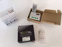Photo showing three LED controllers in original boxes - Decodel Professional, LTECH DX Series, and LED2014X Dream-Color Controller with remote.