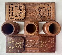 Top view showing the two wooden jars and square jar with removable lid, along with extended carved bookend panels.