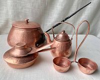 Front view of the complete set showing pot, kettle, warmer, handled server, and cups on a neutral background.