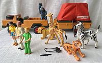 Full lot including safari truck, trailer, red fabric canopy, animal figures, human figures and accessories