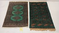 Two hand-knotted Indo Bokhara rugs side by side showing full view with fringed edges.