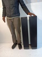 Pair of Klipsch RF-42 II floorstanding speakers next to a person for size reference.
