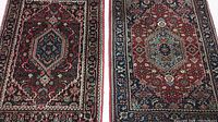 Close-up of two rugs side by side showing pattern and color