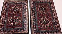 Two hand-knotted Persian style area rugs laid side by side showing geometric floral patterns with red backgrounds, black borders, and beige accents.