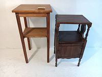 Two vintage wooden side tables together showing the difference in style and color. Right table dark wood with a cabinet door; left table lighter wood with drawer and shelf.