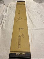 Box of B'TWIN bike work stand showing illustrations of the stand and branding