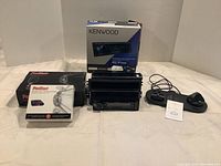 Full lot including ProStart remote car starter boxes, Kenwood CD receiver with box and base unit, and multi hub charger with cables.