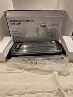 Quartz heater placed in front of its white retail box showing front view and packaging information.