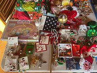 Wide view of assorted holiday decor and jewelry items arranged on tables covering multiple holidays including Christmas, Easter, Halloween, Saint Patrick's Day, Valentine's Day, and Fourth of July.