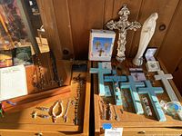 Overall view of table showing book stand, books, jewelry and religious decor