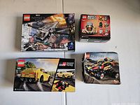 Top view showing all four sealed LEGO boxes: Quinjet Infinity Saga, BrickHeadz Chicken, Toyota Gazoo Racing Supra, and Technic Buggy.