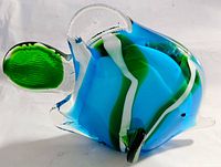 Close-up side view of the glass fish showing its colorful details and clear glass fins.