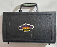 Black hard carrying case with a handle and a sticker labeled 'POWER 95 WAQZ-FM' on the front.