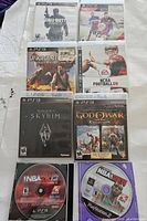 Photo showing 7 PlayStation 3 game cases and 2 NBA 2K discs, one for PS3, one for PS2