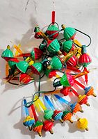Photo showing an assorted lot of vintage Christmas bubble lights with green, red, yellow bases and clear and colored tubes.