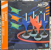 Original boxed packaging of Nerf Lawn Dart set, showing 4 darts with fins, suction cup bases, and tossing target ring graphics