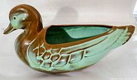 Side view of vintage Frankoma duck planter showing brown and teal glaze with detailed feathers