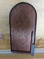 Front view of the wooden mechanical pinball game showing pin layout and lever.