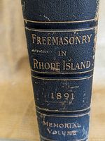 Close-up of book spine showing title, year 1891, and 'Memorial Volume' text