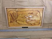 Front view of framed wood carving depicting four fish and underwater plants with a plaque labeled 'Wall Fish'.