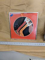 Framed John L. Eastman 1973 serigraph with ruler showing size and overall design.